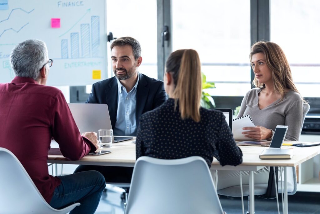 business-people-discussing-together-in-conference-room-during-meeting-at-office--e1661691516873.jpg